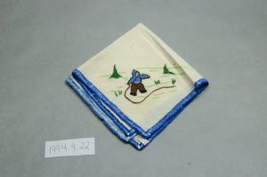 Image of Embroidered napkin with scene of Inuit boy cracking a whip